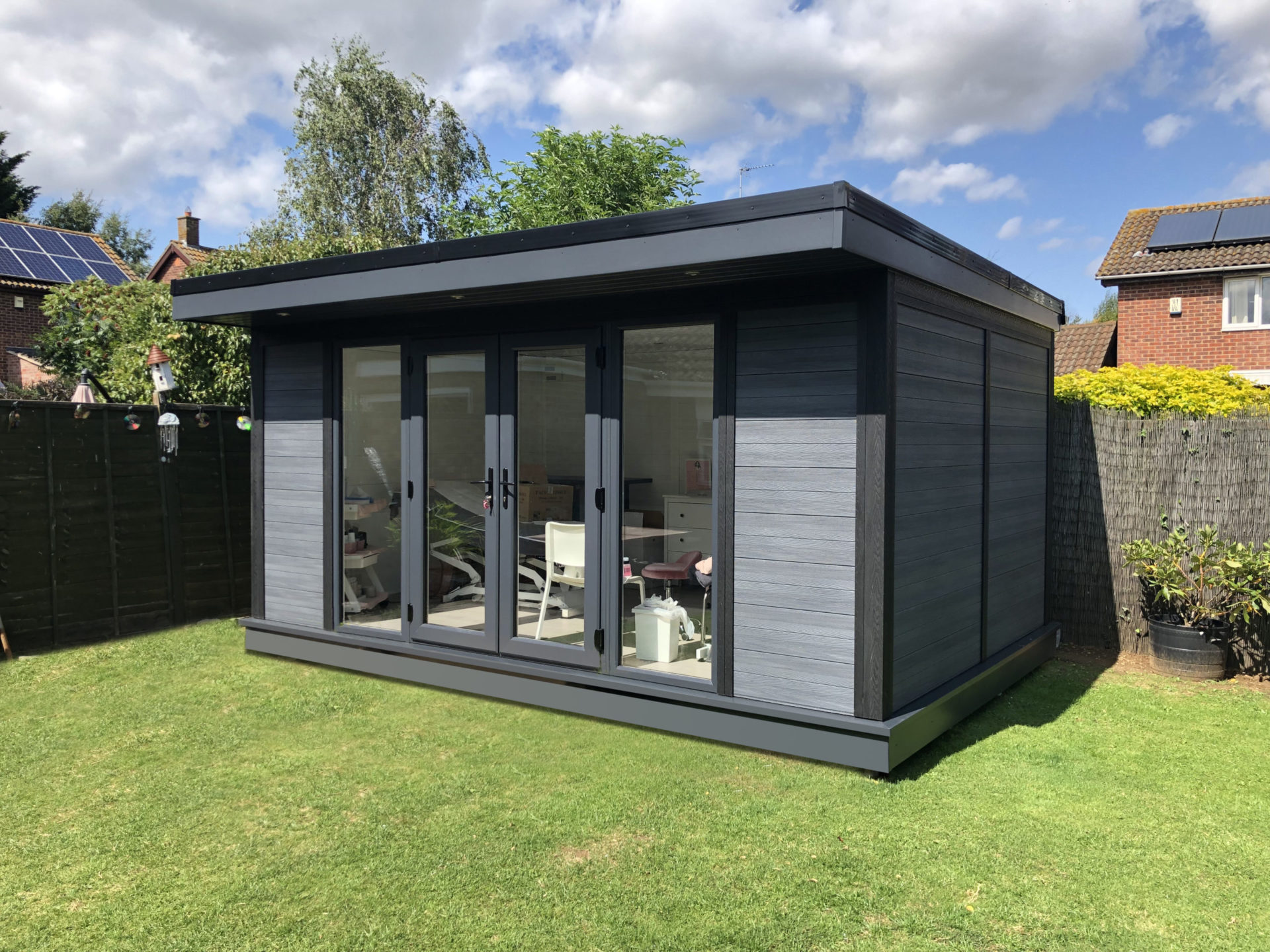 Garden Room in corner of garden on sunny day